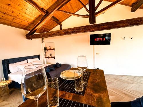 a room with wine glasses on a table in front of a bed at Suite del Castello in Massino Visconti