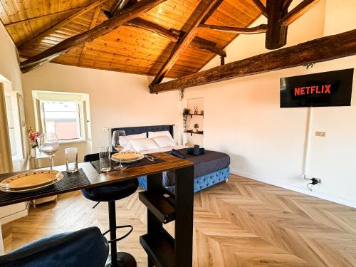 a room with a bed and a table and a sign at Suite del Castello in Massino Visconti