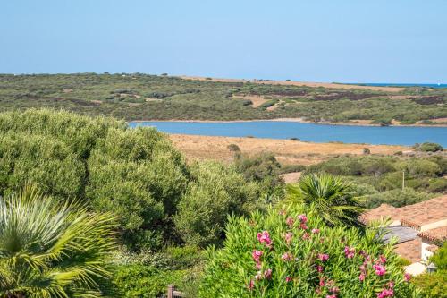 a view of a body of water with trees and flowers at Villa Selena in Cuile Pazzoni