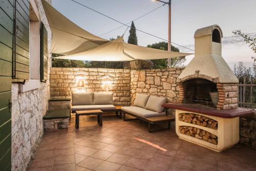 a outdoor patio with a fireplace and a tent at Villa Lilly in Višnjan