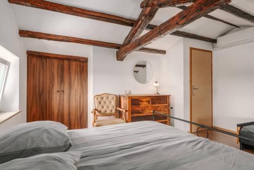 a bedroom with a bed and a chair at Villa Lilly in Višnjan