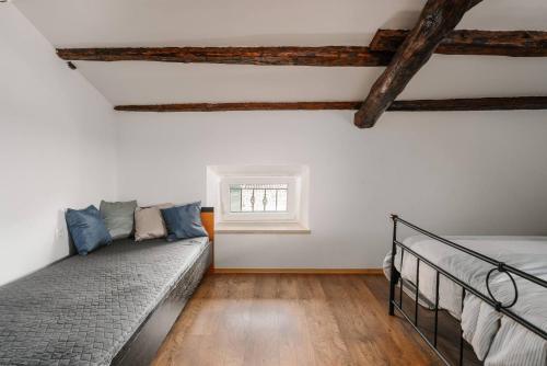 a bedroom with a bed and a window at Villa Lilly in Višnjan