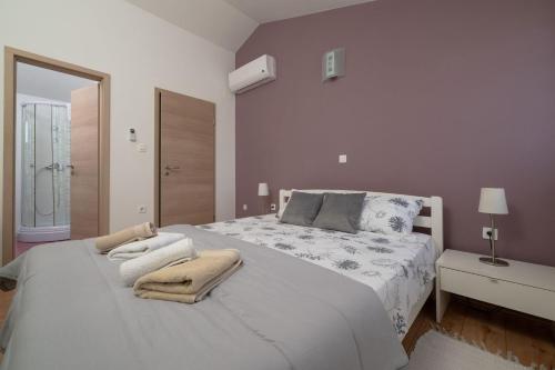 a bedroom with a white bed with towels on it at Villa Daus in Cerovlje