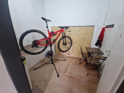 a red bike is on a stand in a room at apartmán Meluzínka in Loučná pod Klínovcem