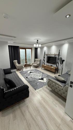 a living room with a couch and a television at Sağlam PANSİYON in Uzungöl