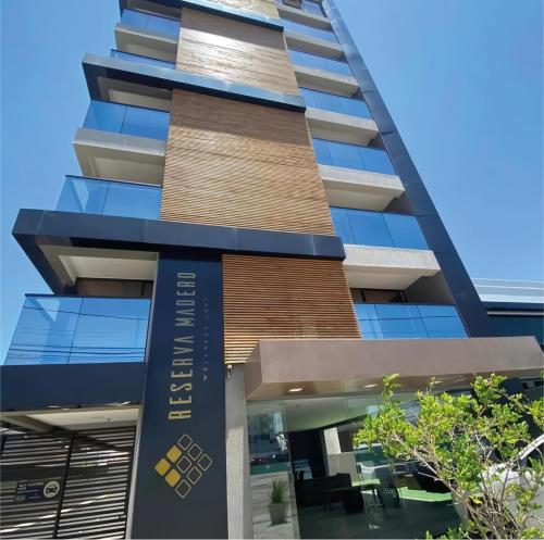 a building with a sign on the side of it at Reserva Madero 201 Vista Mar in Natal