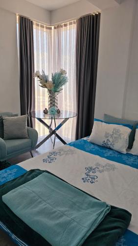 a room with two beds and a table and a window at Lake DREAM NINO 1 in Star Dojran