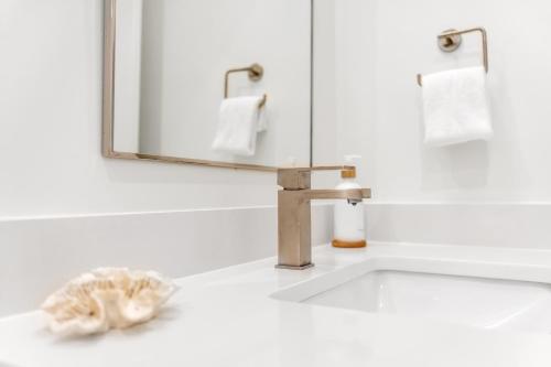 a bathroom with a sink and a mirror at The Hangout House Relaxed 4BR Luxury, 3 King Suites, Walk to Beach, Pet Friendly in Gulf Shores