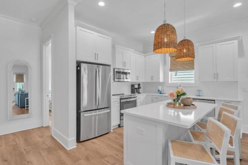 a kitchen with white cabinets and a white counter top at The Hangout House Relaxed 4BR Luxury, 3 King Suites, Walk to Beach, Pet Friendly in Gulf Shores