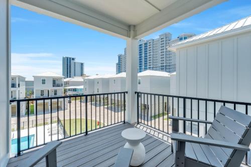 a balcony with two chairs and a view of the city at The Hangout House Relaxed 4BR Luxury, 3 King Suites, Walk to Beach, Pet Friendly in Gulf Shores