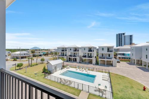 an aerial view of a apartment complex with a swimming pool at The Hangout House Relaxed 4BR Luxury, 3 King Suites, Walk to Beach, Pet Friendly in Gulf Shores