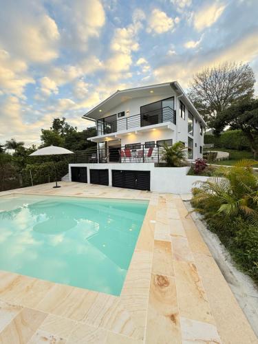a house with a swimming pool in front of a house at Villa Verde in Silvania