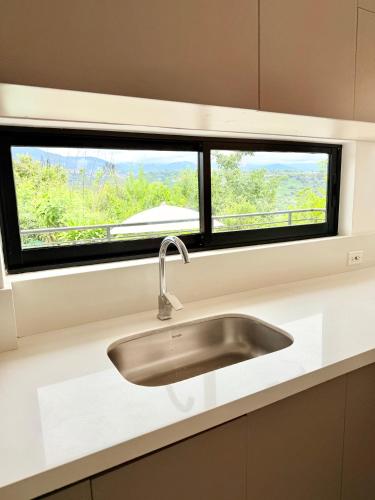 a sink in a kitchen with a window at Villa Verde in Silvania