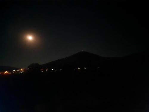 a full moon over a mountain at night at Rooms Vidović in Međugorje