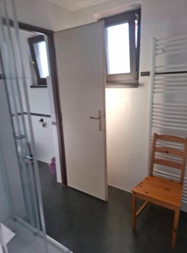a room with a door and a chair and a window at Sluneční villa Terezka Lednice ,penzion pro skupiny se snídaní,degustací vín in Lednice