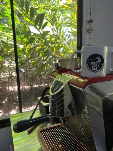 a coffee cup sitting on top of a machine at Villas Itaita Beach Cabins in Punta Uva