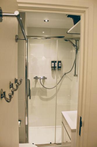 a bathroom with a shower and a sink at Bougie Studio by St Pauls in London