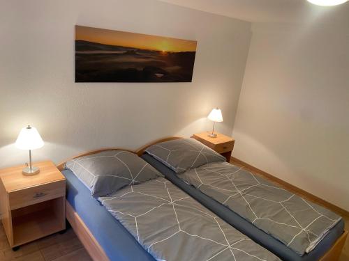 1 cama en una habitación con 2 lámparas en las mesas en Ferienwohnung Pintaske, en Stadt Wehlen