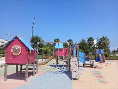 a park with a playground with a slide at Studio Moderne avec Vue sur piscine et proche de la plage à Ocean Park Zenata Eco City in Aïn Harrouda