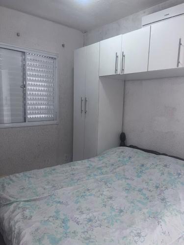 een slaapkamer met een bed, witte kasten en een raam bij Condomínio Moradas Club Rios do Pará COP 30 in Ananindeua