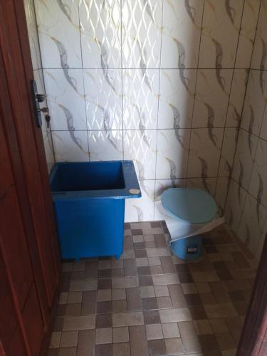 a bathroom with a blue sink and a toilet at Rima Homestay in Kri