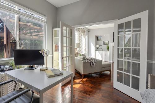 a living room with a desk with a computer on it at New Reno Retreat 72 Inch TV Office Patio Views in Reno