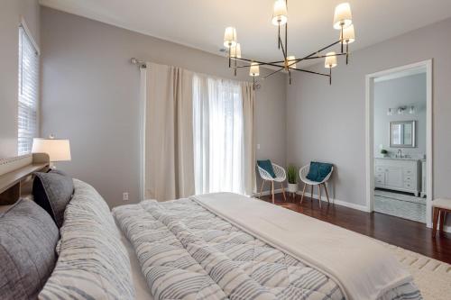 a bedroom with a large bed and a chandelier at New Reno Retreat 72 Inch TV Office Patio Views in Reno