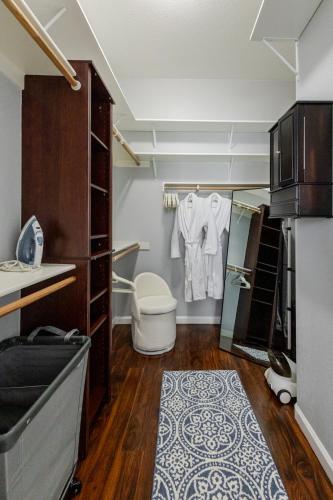 a small bathroom with a toilet and a closet at New Reno Retreat 72 Inch TV Office Patio Views in Reno