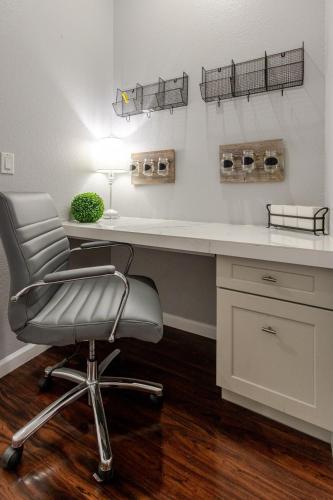 a desk with a chair in a room at New Reno Retreat 72 Inch TV Office Patio Views in Reno