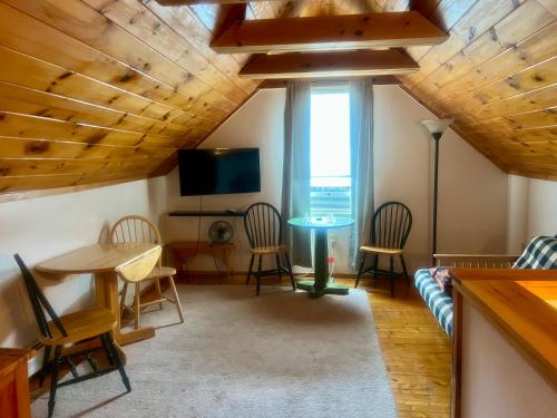 a living room with a table and chairs at Allegory Inn in Twin Mountain