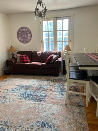 a living room with a couch and a table at Allegory Inn in Twin Mountain