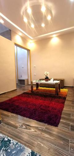 a room with a table and a red rug at Aladdin hotel Egypt badr in Badr