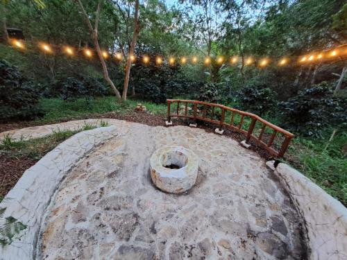 a wooden bench sitting on top of a stone patio at Ana Lucia-Casa del arbol in Aratoca
