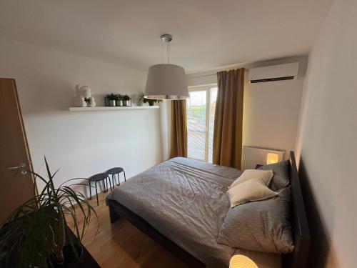 a bedroom with a bed and a window at Apartment Loft Fifteen in Dunajská Streda