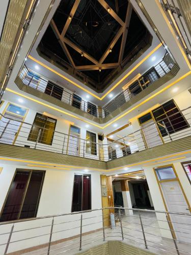 a large room with windows and a ceiling at HR Guest House in Gilgit