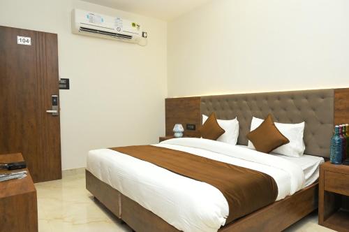 a bedroom with a large bed in a room at Hotel sapphire in Gwalior