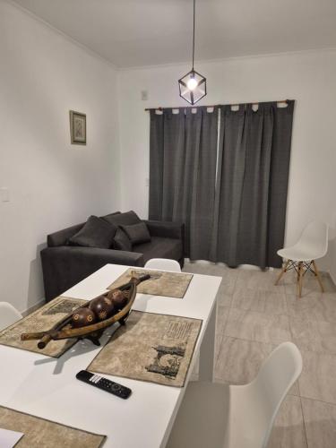 a living room with a table and a couch at Del Sur Alquiler temporario in Sunchales