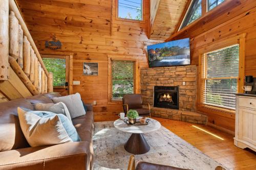a living room with a couch and a fireplace at Serenity Escape in Sevierville