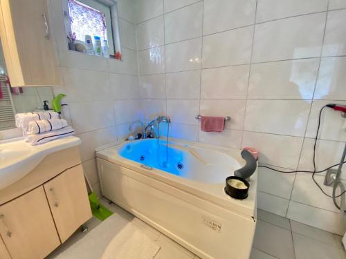 a bathroom with a tub and a sink at miris dunja in Sarajevo