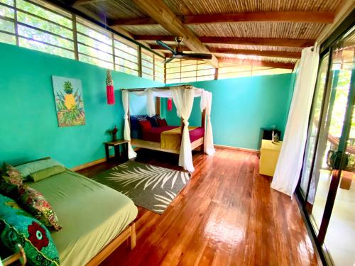 a bedroom with a bed with a canopy at La Shamana - Ecological Concept in Jungle in Cahuita