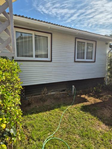 a house with a hose in the yard at Casas Pamelas in Algarrobo
