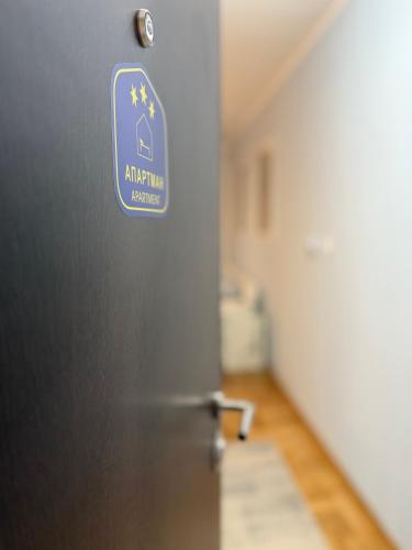 a door of a refrigerator with a sign on it at Apartman Indigo in Vrnjačka Banja