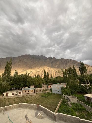 a view of a resort with mountains in the background at Aba-SHAH GUEST HOUSE SKARDU in Skardu