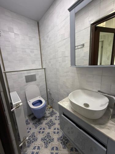 a bathroom with a sink and a toilet and a mirror at Tsikhisdziri sea view in Tsikhisdziri