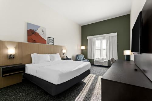 a hotel room with a large bed and a television at Spark by Hilton Panama City Beach in Panama City Beach