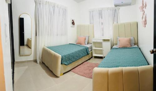 a bedroom with two beds and a mirror at Luxurious and comfortable 1 level in Ensanche Savica de Mendoza