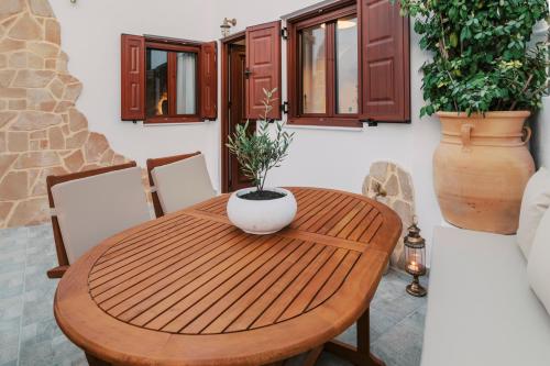 a wooden dining room table with a vase on it at Lindos Zen luxury villa in Líndos