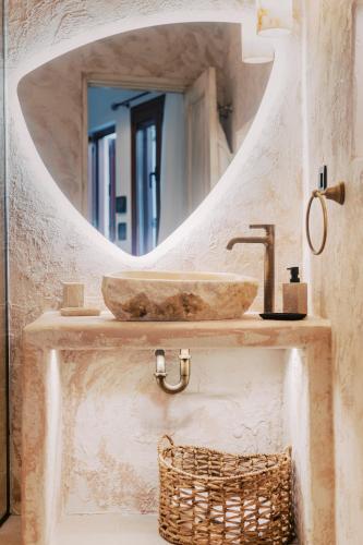 a bathroom with a sink and a mirror at Lindos Zen luxury villa in Líndos