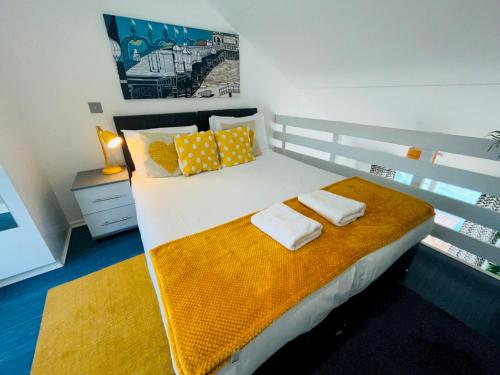 a bedroom with a bed with two towels on it at On the Water 2 A One-of-a-Kind Stay Free Parking By My Getaways in Brighton & Hove