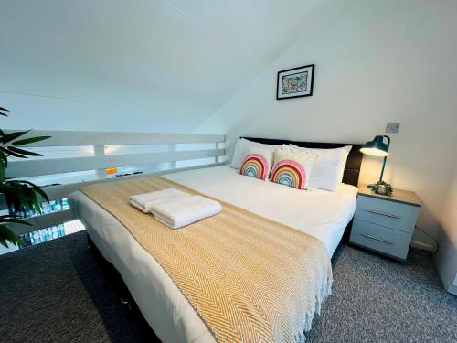 a bedroom with a bed and a lamp and a plant at On the Water 3 with Free Parking By My Getaways in Brighton & Hove
